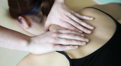 Close up of healthcare practitioners hands massaging dancers sholder