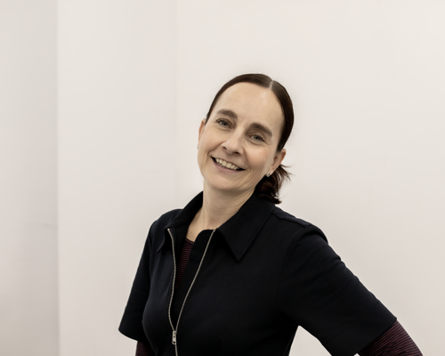 Image of Sam Lane, a woman with brown hair smiling at the camera