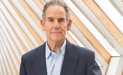 white male from The Royal Ballet School wearing grey suit and blue shirt